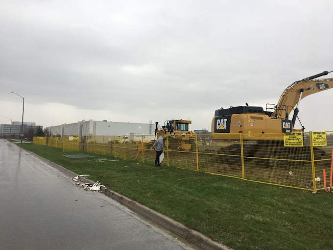 Temporary construction fence panels with pricing information for rental projects in GTA, Ottawa and Montreal